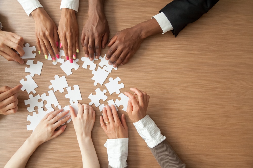 Employee hands touching a puzzle